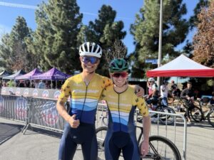 Two members of the UCSD cycling team standing in uniform at the end of race