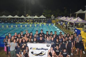 Swim team in front of pool 