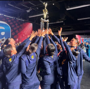 UCSD Dance Team holds up trophy with second place victory. 