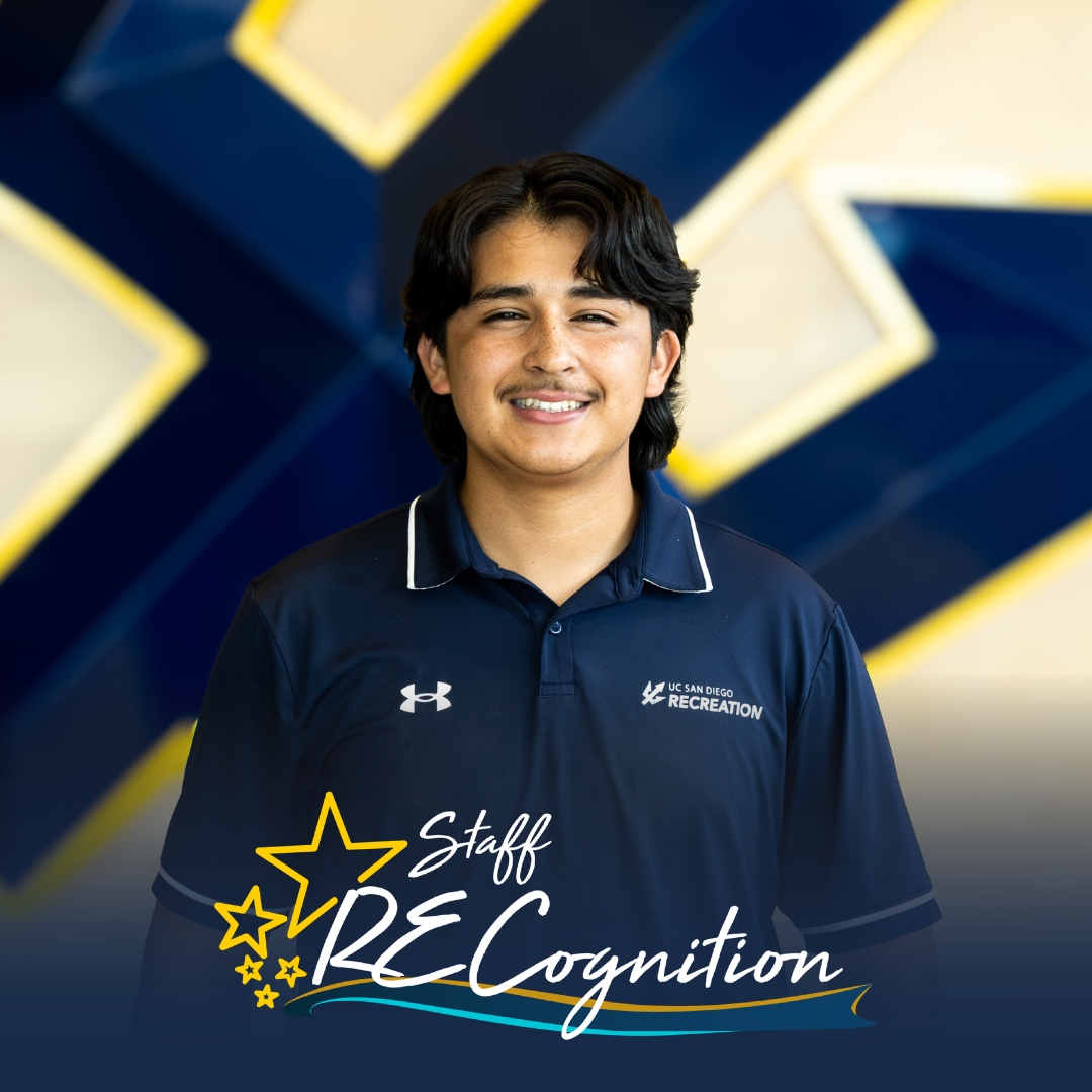 Angelo, a young man with dark hair wearing a blue polo, stands before a wooden wall with a blue UCSD Trident. A Staff RECognition logo is shown at the bottom.