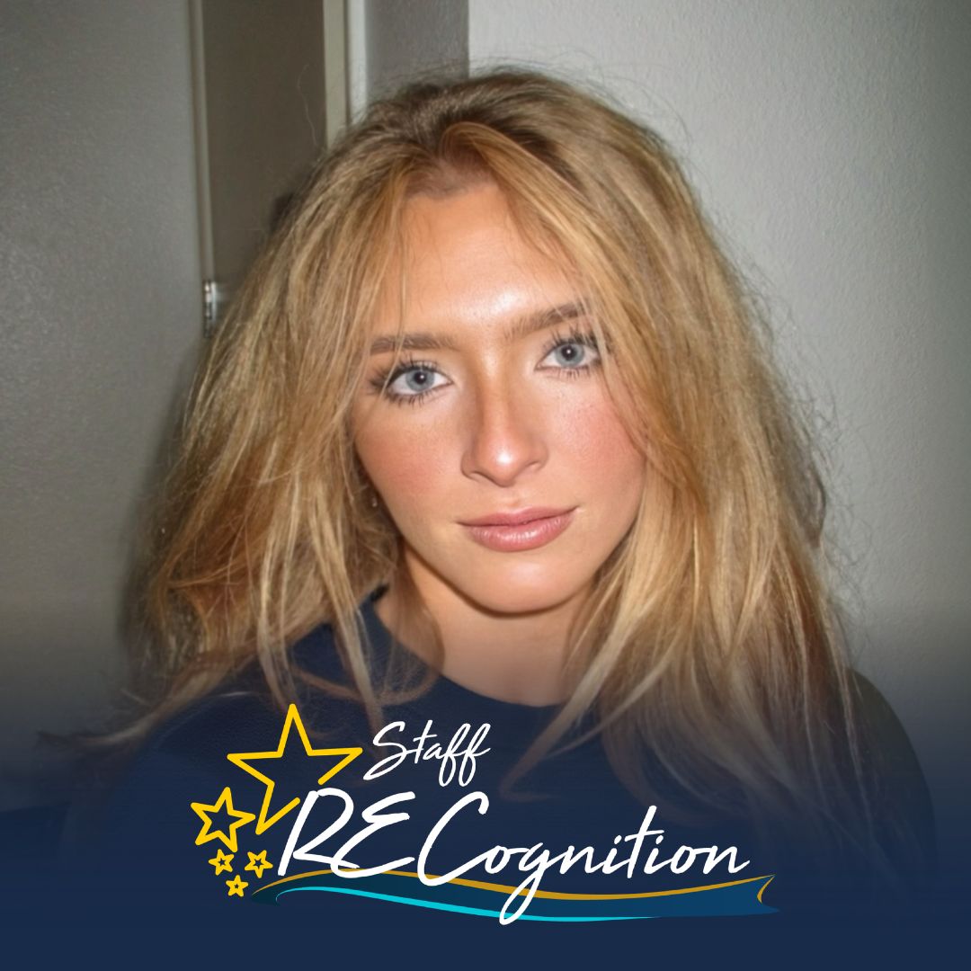Julia Fitzpatrick is a young woman with blonde hair. She wears a blue crewneck shirt. At the bottom is a blue and white Staff RECognition logo.